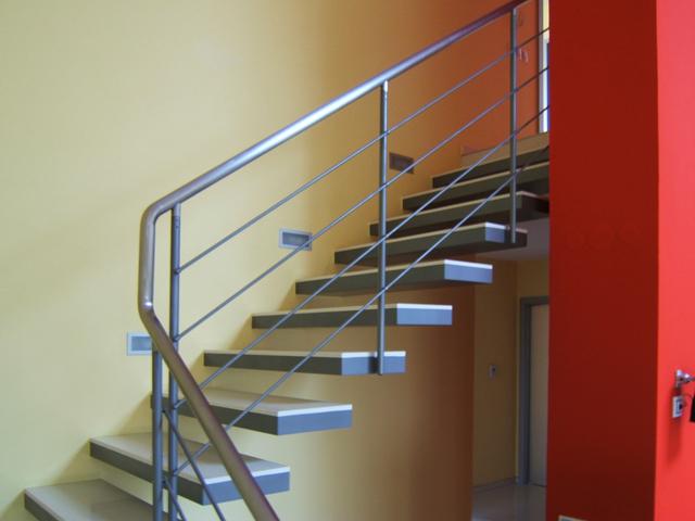 Straight staircase with open treads and a steel cable railing