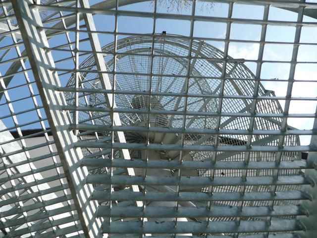 Exterior steel spiral staircase with a mesh cage